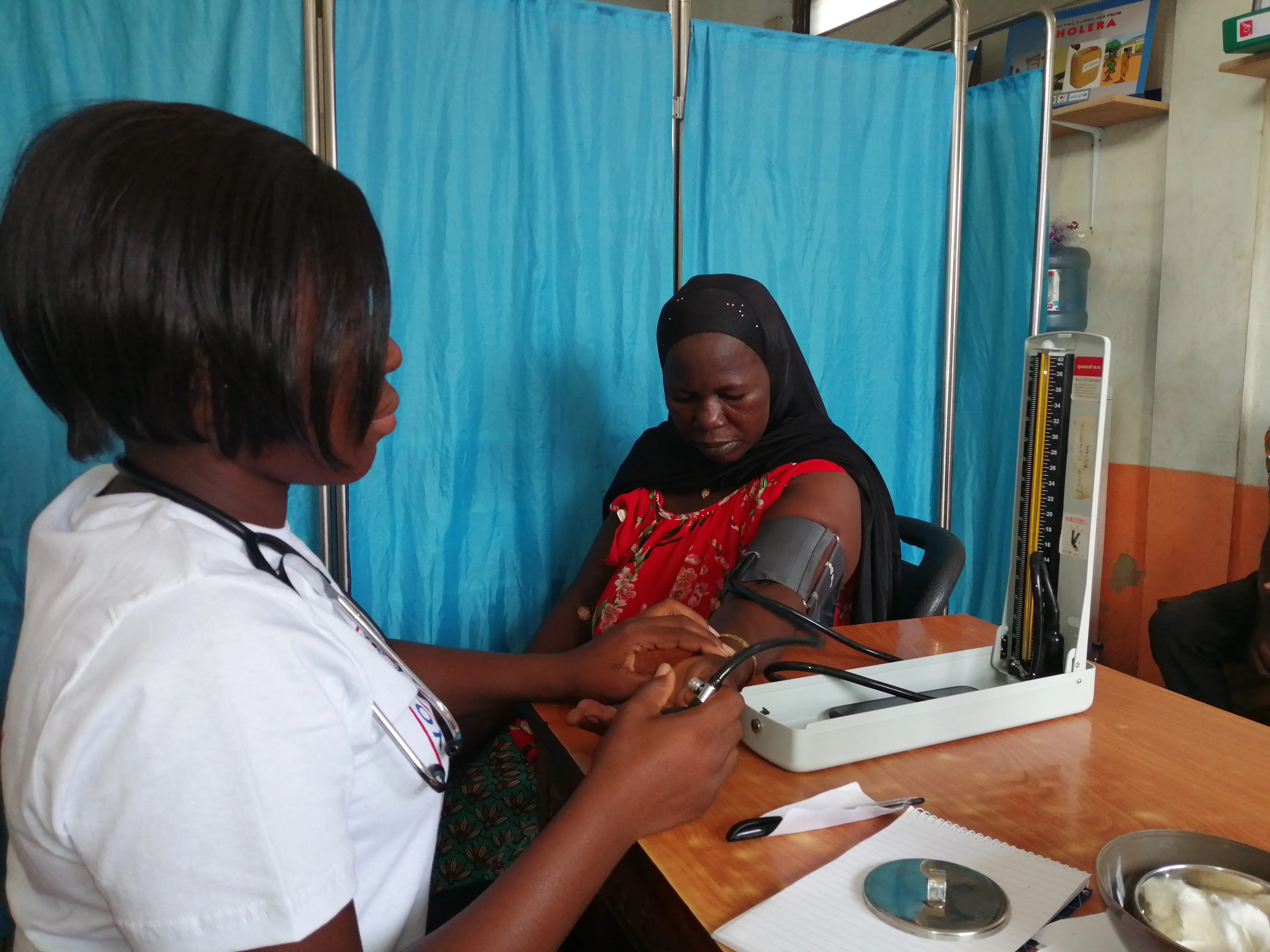 Health worker checks a patient's blood pressure